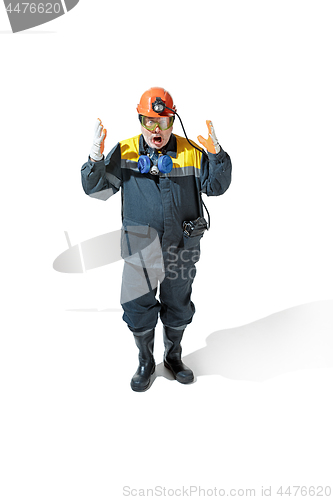 Image of The studio shot of senior bearded male miner standing at the camera on a white background.