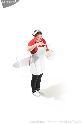 Image of Portrait of cute smiling woman with bowl in her hands in the studio, isolated on white background
