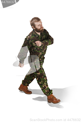 Image of Young army soldier wearing camouflage uniform isolated on white