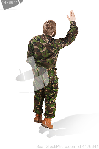 Image of Young army soldier wearing camouflage uniform isolated on white