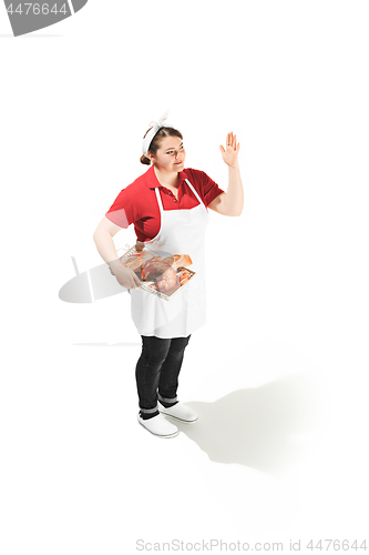 Image of Portrait of cute smiling woman with pastries in her hands in the studio, isolated on white background