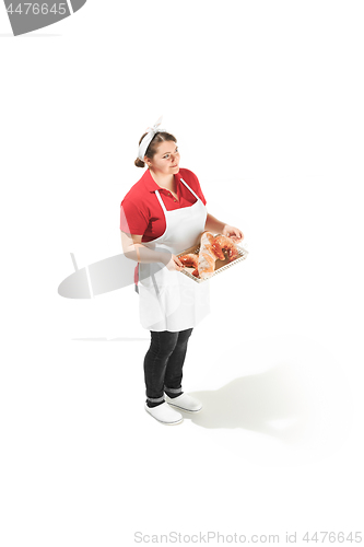 Image of Portrait of cute smiling woman with pastries in her hands in the studio, isolated on white background