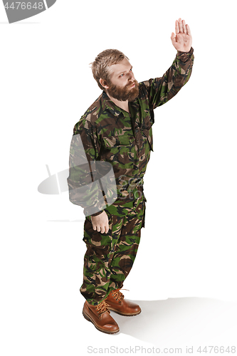 Image of Young army soldier wearing camouflage uniform isolated on white