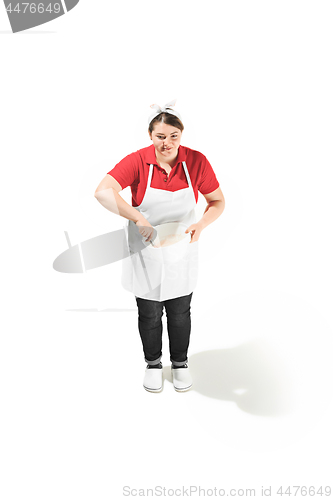Image of Portrait of cute smiling woman with bowl in her hands in the studio, isolated on white background