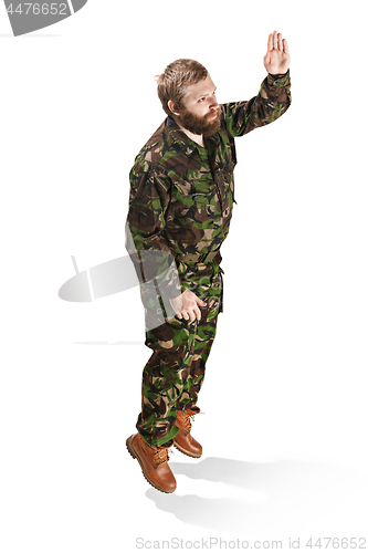 Image of Young army soldier wearing camouflage uniform isolated on white