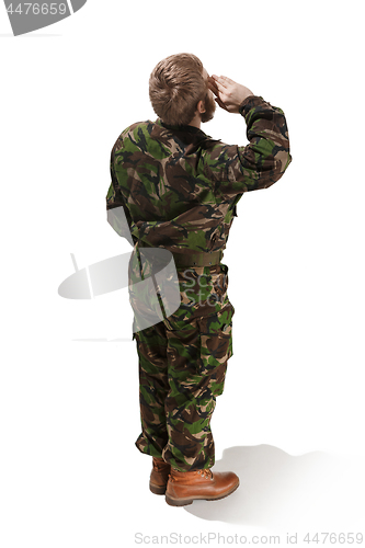 Image of Young army soldier wearing camouflage uniform isolated on white