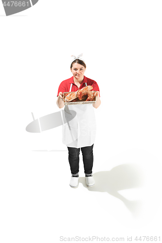 Image of Portrait of cute smiling woman with pastries in her hands in the studio, isolated on white background