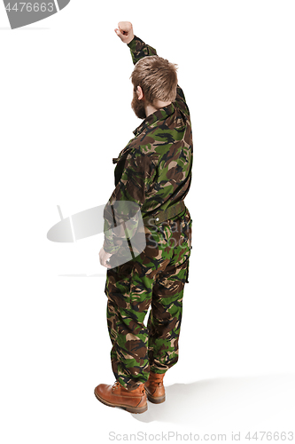 Image of Young army soldier wearing camouflage uniform isolated on white