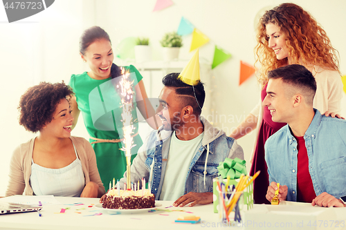 Image of office team greeting colleague at birthday party