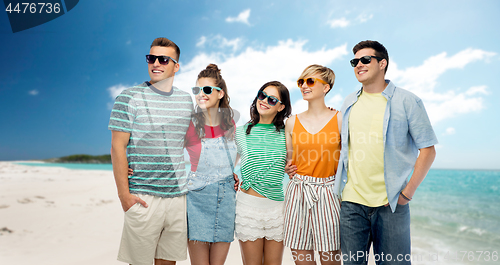Image of friends in sunglasses over tropical beach