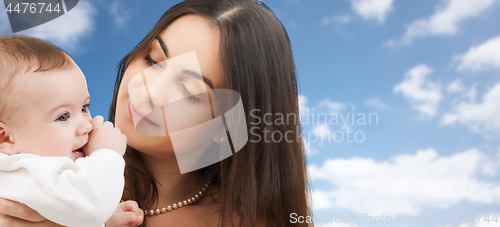 Image of mother with baby over sky background