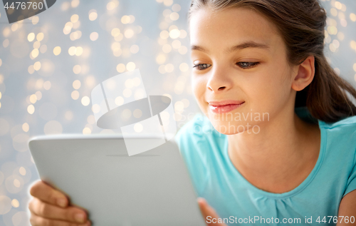 Image of close up of smiling girl with tablet pc