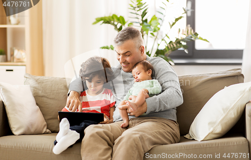 Image of happy father with preteen and baby son at home