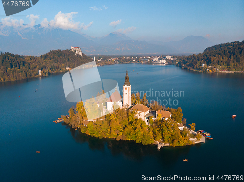 Image of Aerial view of Bled island on lake Bled, and Bled castle and mountains in background, Slovenia.