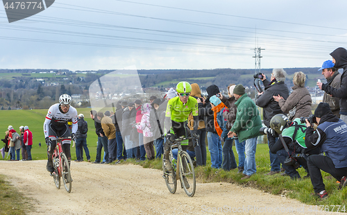 Image of Two Cyclists on a Dirty Road - Paris-Nice 2016