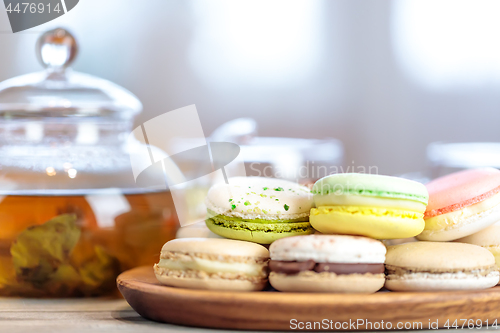 Image of Close-up of colorful macaron (macaroon) on the table with hot te