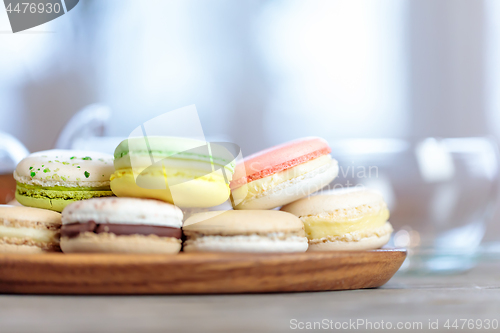 Image of Close-up of colorful macaron (macaroon) on the table with hot te