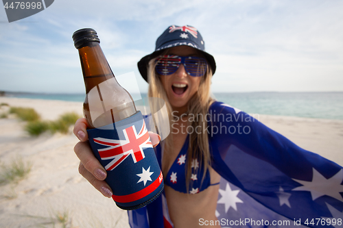 Image of Woman celebrate Australia Day with beer