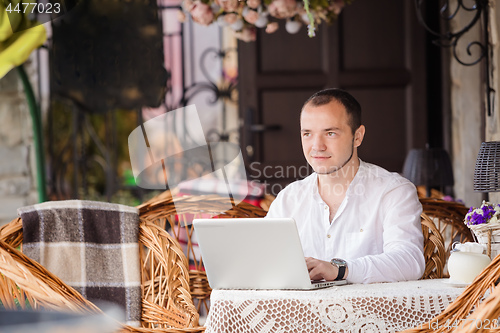 Image of man internet browsing at the cafe bar.