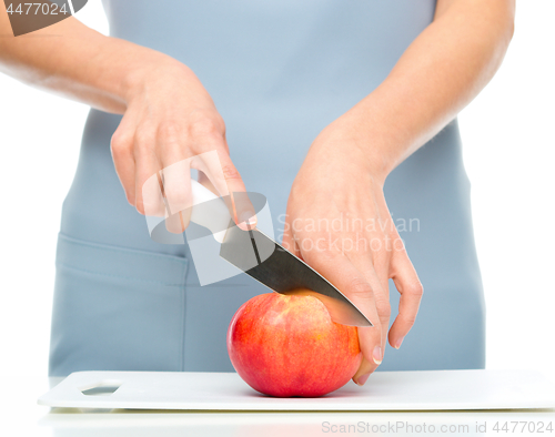 Image of Cook is chopping apple