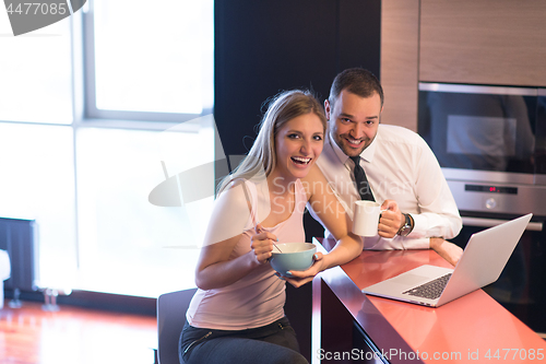 Image of A young couple is preparing for a job and using a laptop