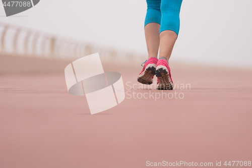 Image of woman busy running on the promenade