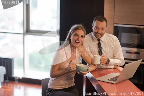 Image of A young couple is preparing for a job and using a laptop