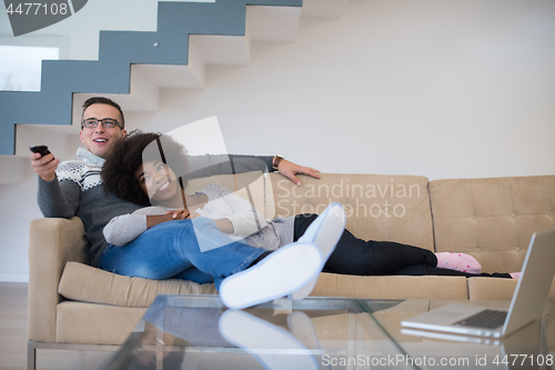 Image of multiethnic couple relaxing at home