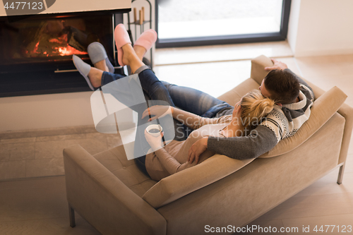 Image of Young couple  in front of fireplace