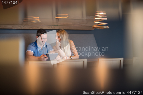 Image of couple using tablet at home