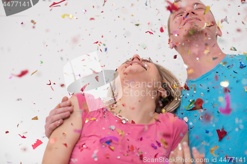 Image of romantic young  couple celebrating  party with confetti