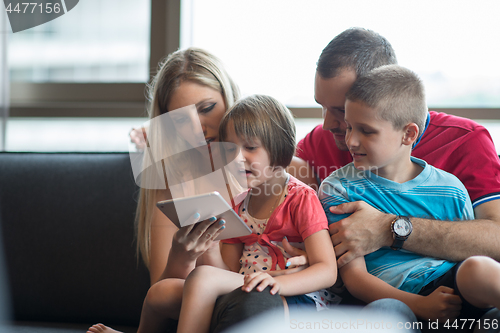 Image of happy young couple spending time with kids