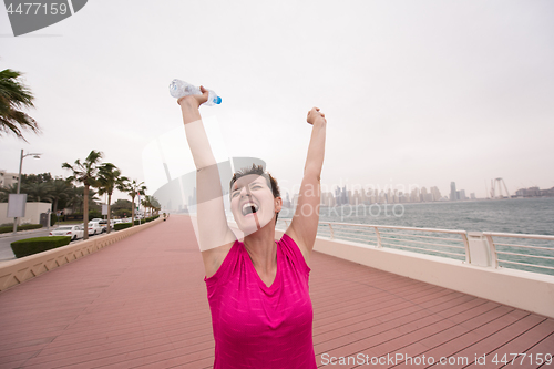 Image of young woman celebrating a successful training run