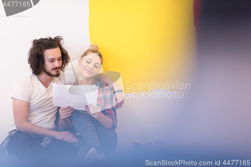 Image of Happy young couple relaxing after painting