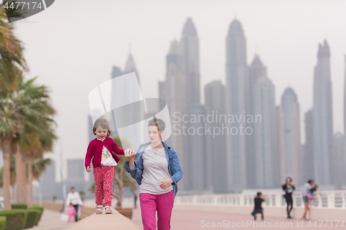 Image of mother and cute little girl on the promenade