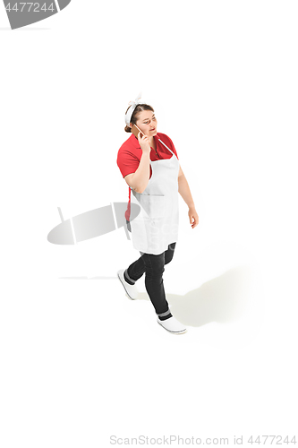 Image of Portrait of cute smiling woman with mobile phone in her hands in the studio, isolated on white background
