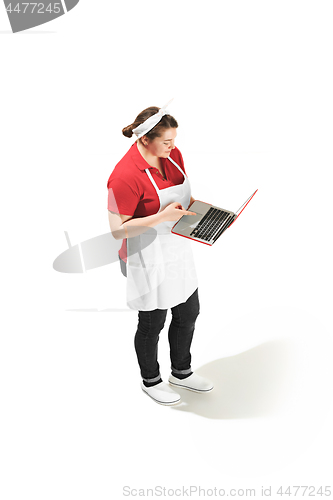 Image of Portrait of cute smiling woman with laptop in her hands in the studio, isolated on white background