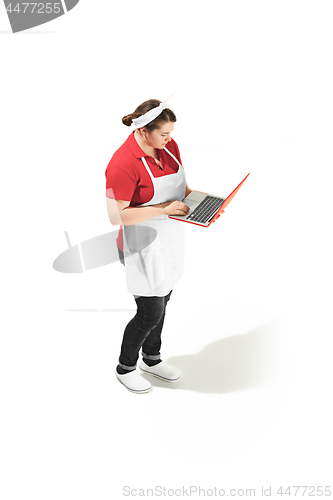 Image of Portrait of cute smiling woman with laptop in her hands in the studio, isolated on white background