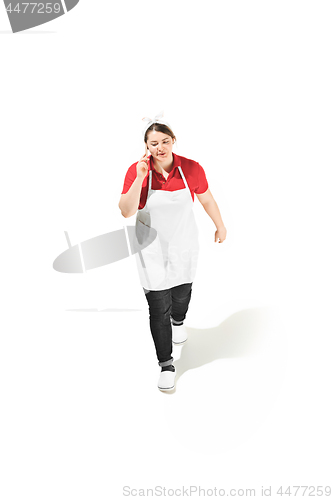 Image of Portrait of cute smiling woman with mobile phone in her hands in the studio, isolated on white background