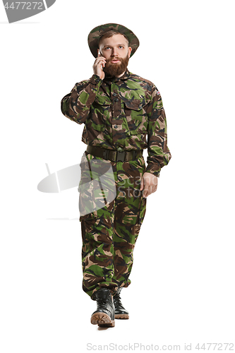 Image of Young army soldier wearing camouflage uniform isolated on white