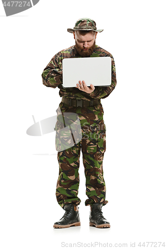 Image of Young army soldier wearing camouflage uniform isolated on white