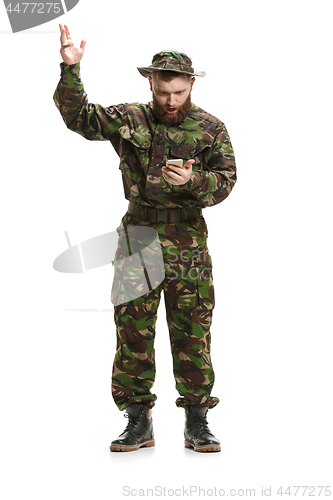 Image of Young army soldier wearing camouflage uniform isolated on white