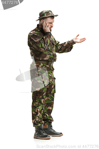 Image of Young army soldier wearing camouflage uniform isolated on white