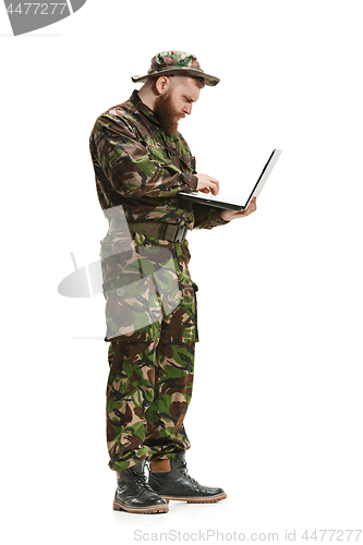 Image of Young army soldier wearing camouflage uniform isolated on white