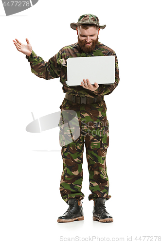 Image of Young army soldier wearing camouflage uniform isolated on white