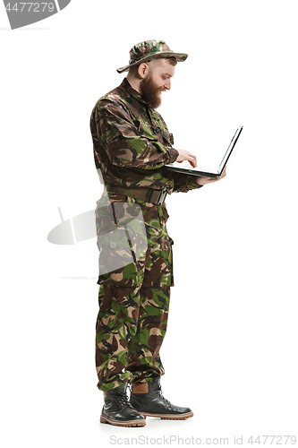 Image of Young army soldier wearing camouflage uniform isolated on white