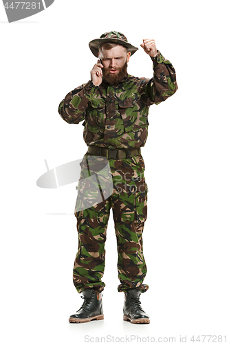 Image of Young army soldier wearing camouflage uniform isolated on white