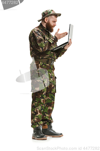 Image of Young army soldier wearing camouflage uniform isolated on white