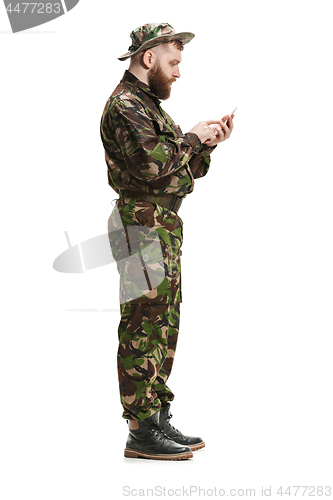 Image of Young army soldier wearing camouflage uniform isolated on white