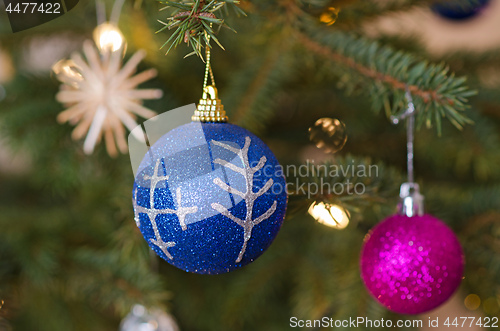 Image of Two decorative balls on christmas tree branch.